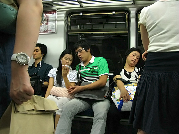 Couple #4....watching broadcast TV on the subway??